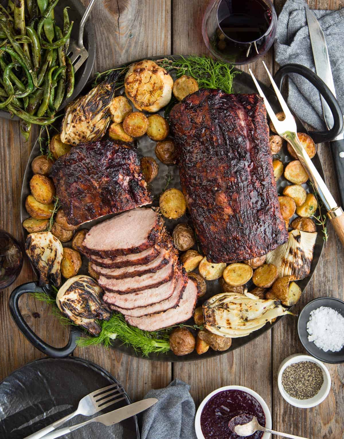 Grilled Pork Loin with Blackberry Wine Glaze on a platter with roasted potatoes