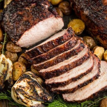 Slices of Grilled Pork Loin on a platter with roasted potatoes