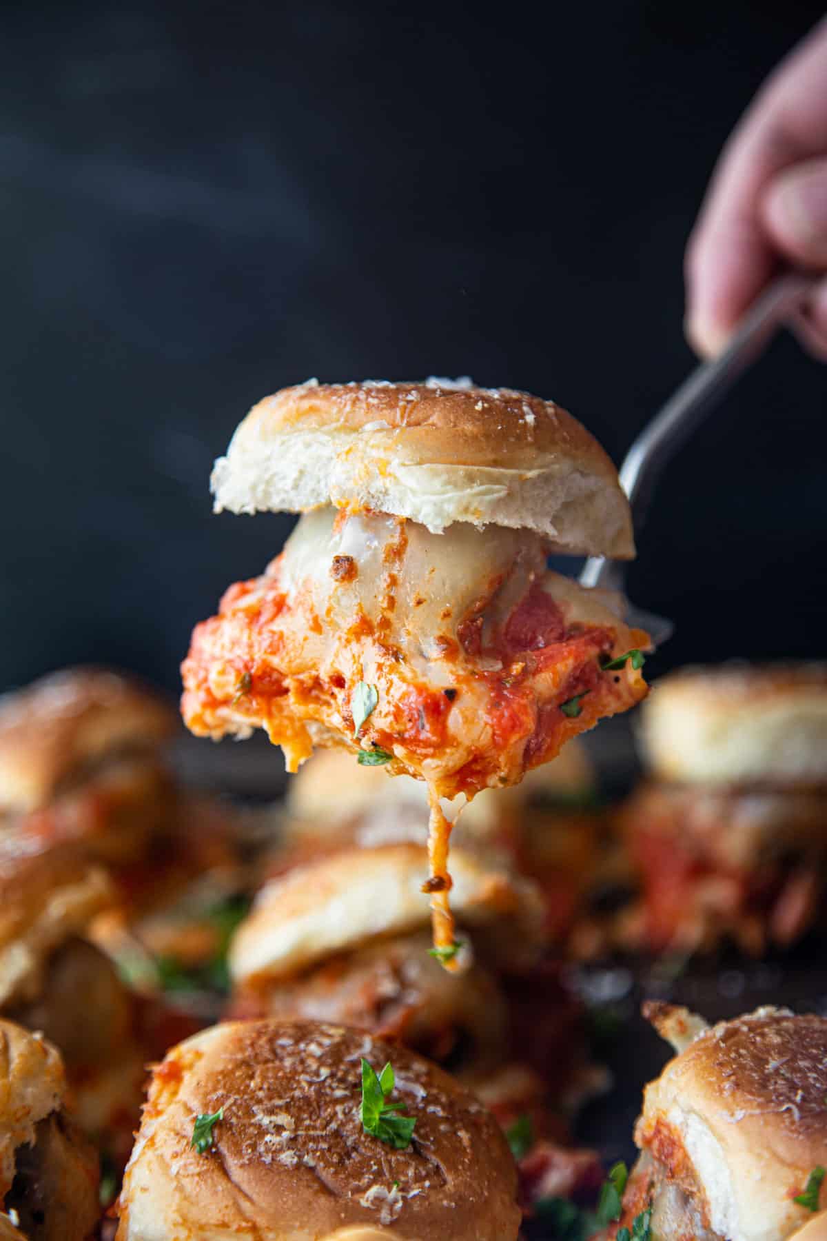 A grilled Italian Meatball Slider on a serving spoon.