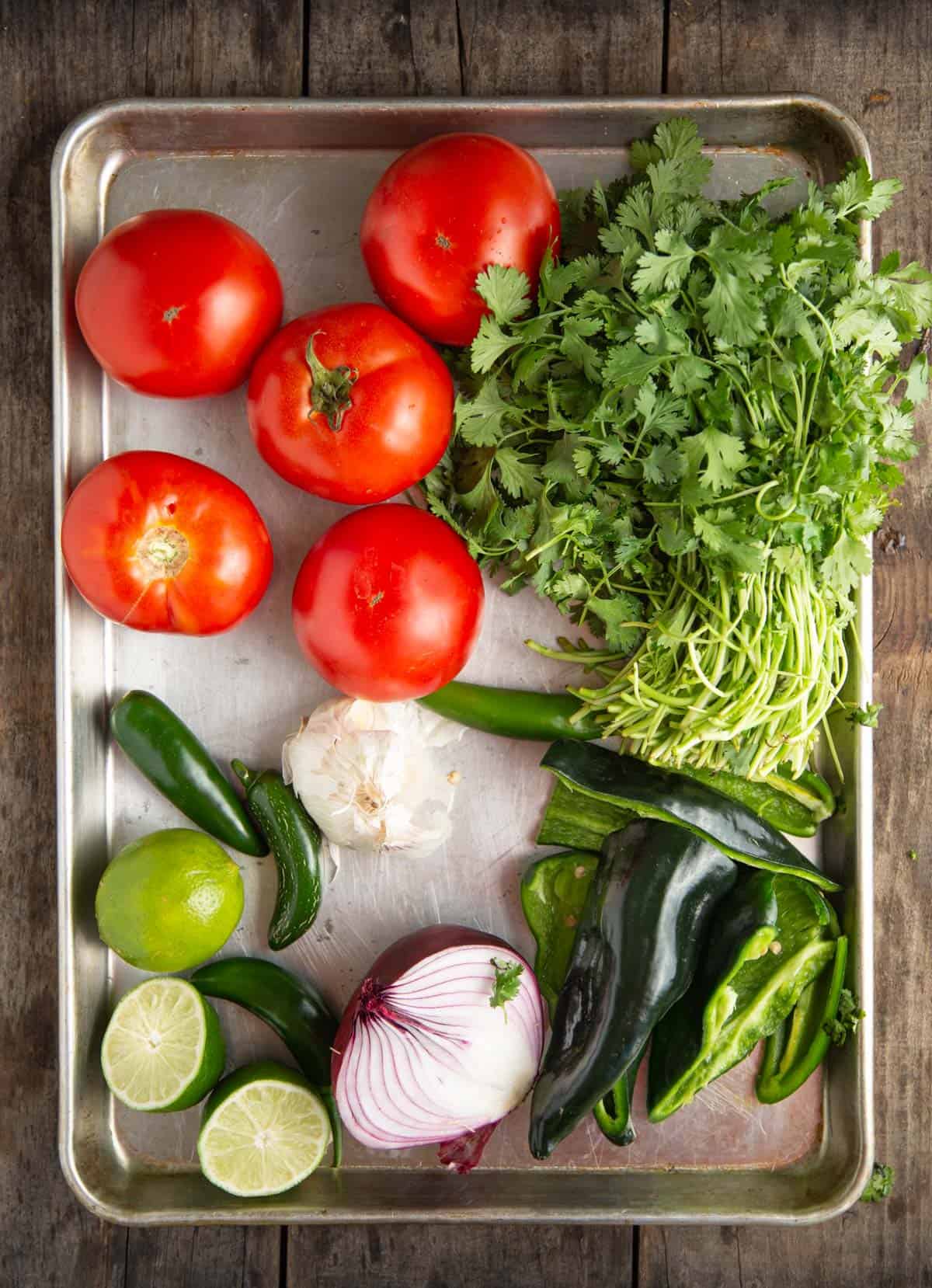 Ingredients for Fire Roasted Tomato Salsa on a sheet pan 