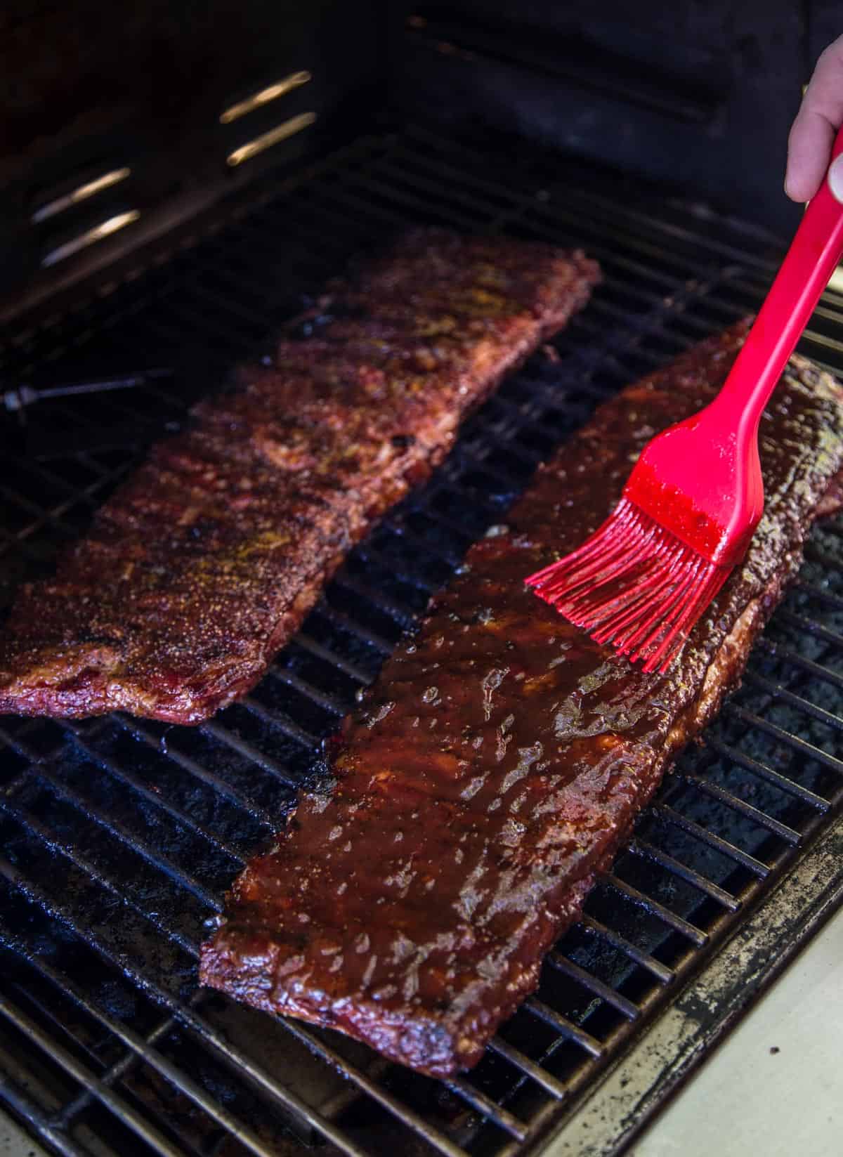 Ribs on the MAK Grill saucing with a basting brush which is an essential grilling accesories.