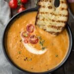 dipping bread in smoked tomato bisque