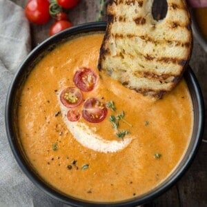 dipping bread in smoked tomato bisque