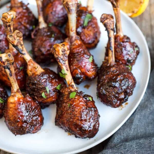 Grilled and glazed chicken legs on a serving platter.
