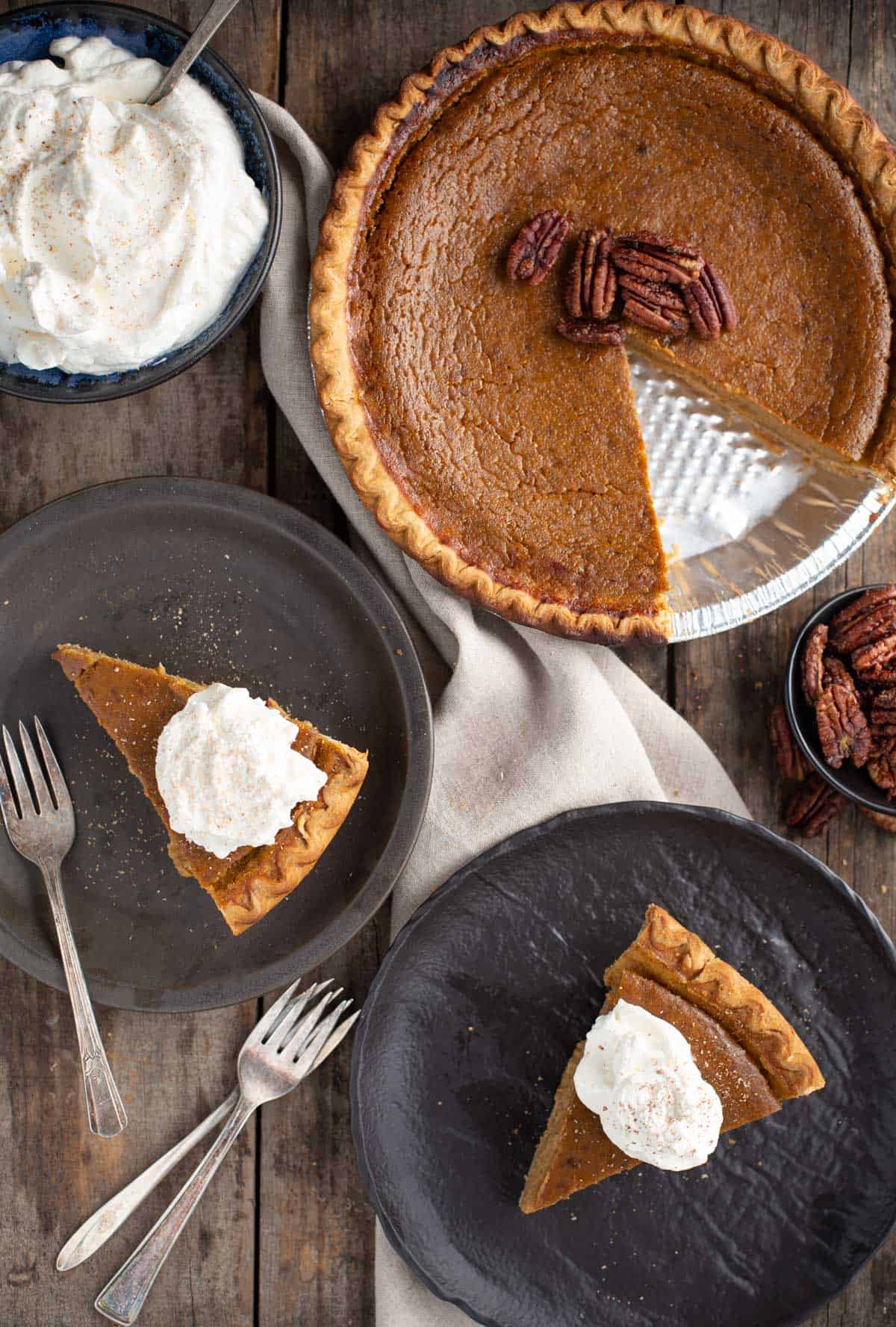 A grilled Pumpkin Pie with candied pecans and two slices on a plates