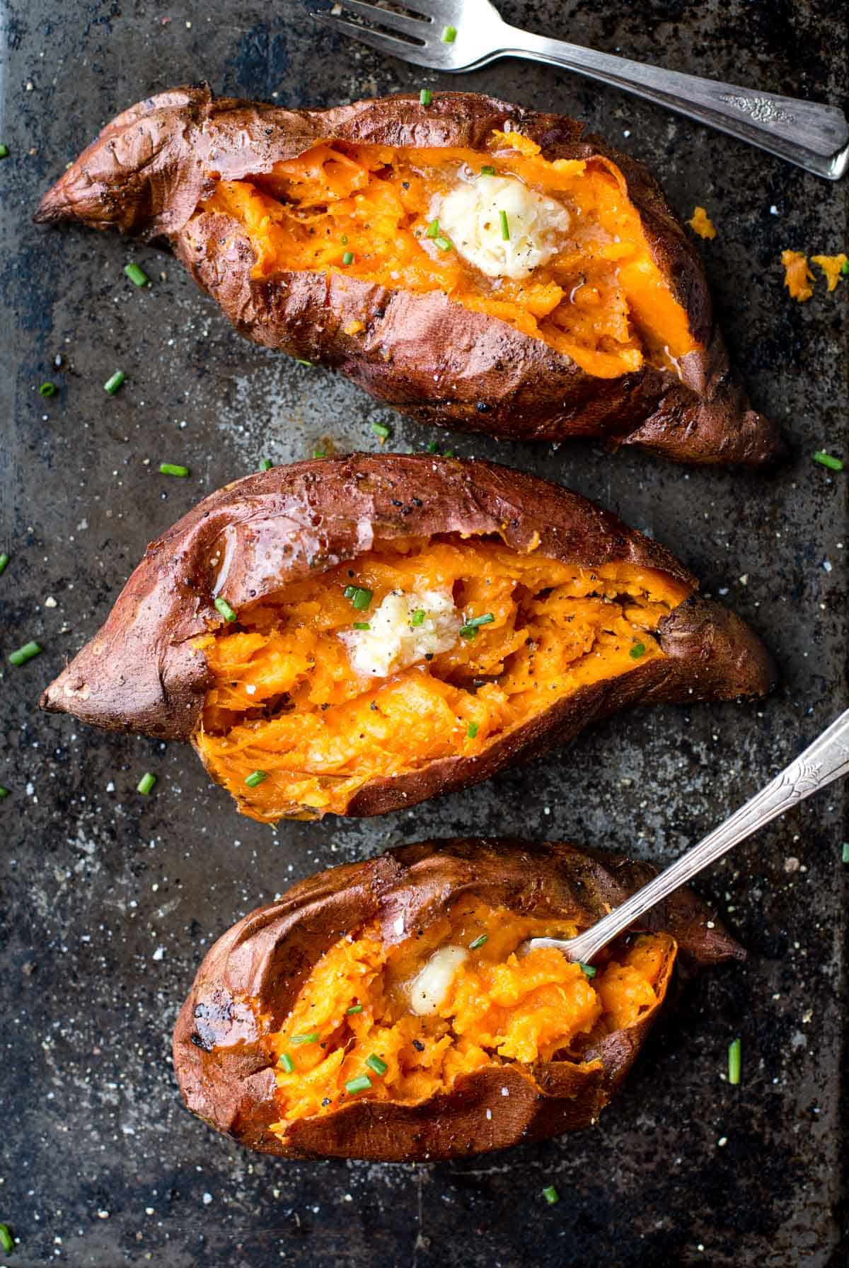 Grilled sweet potatoes' sliced open with smoked honey butter over the top.