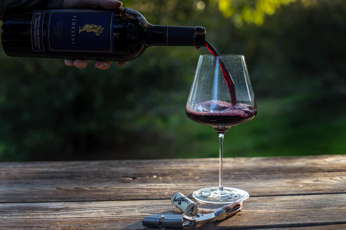 Pouring Merlot wine into a wine glass