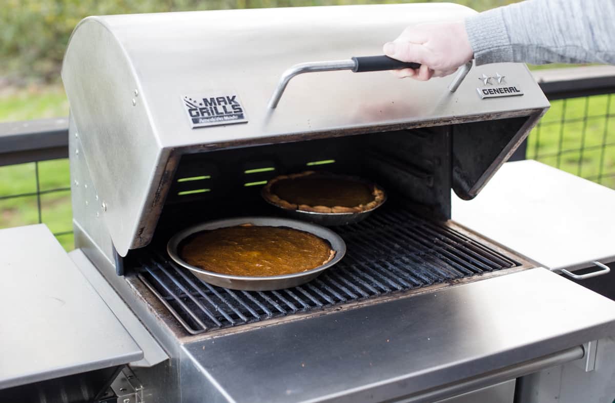 Two pies cooking on a grill