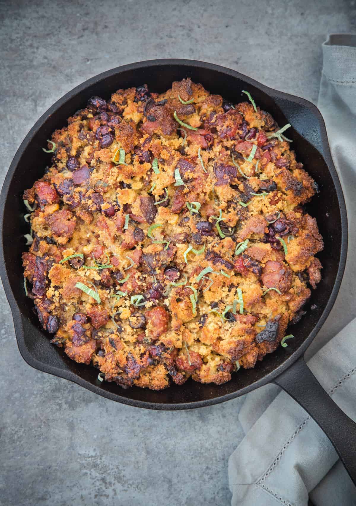 Smoked Sausage Cornbread stuffing in a cast iron pan.