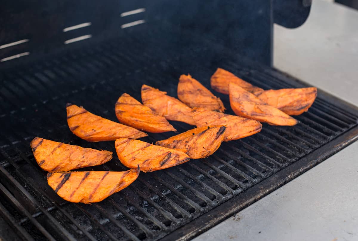 Sweet potatoes cooking on the grill.