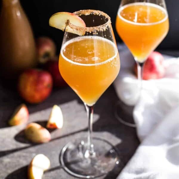 Two apple cider mimosas in glasses.