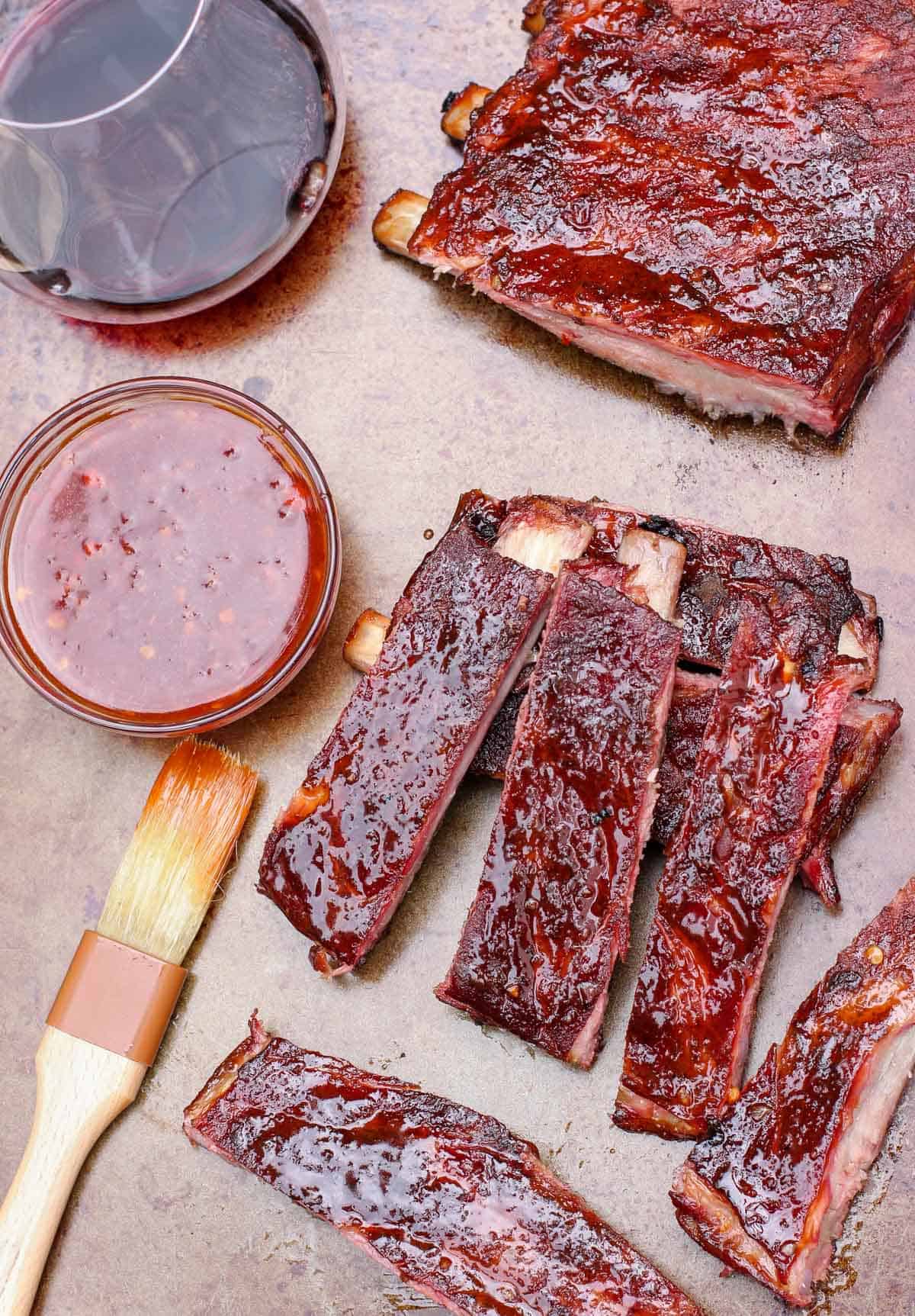 A platter with smoked ribs covered in an Asian Spice rub and sauce
