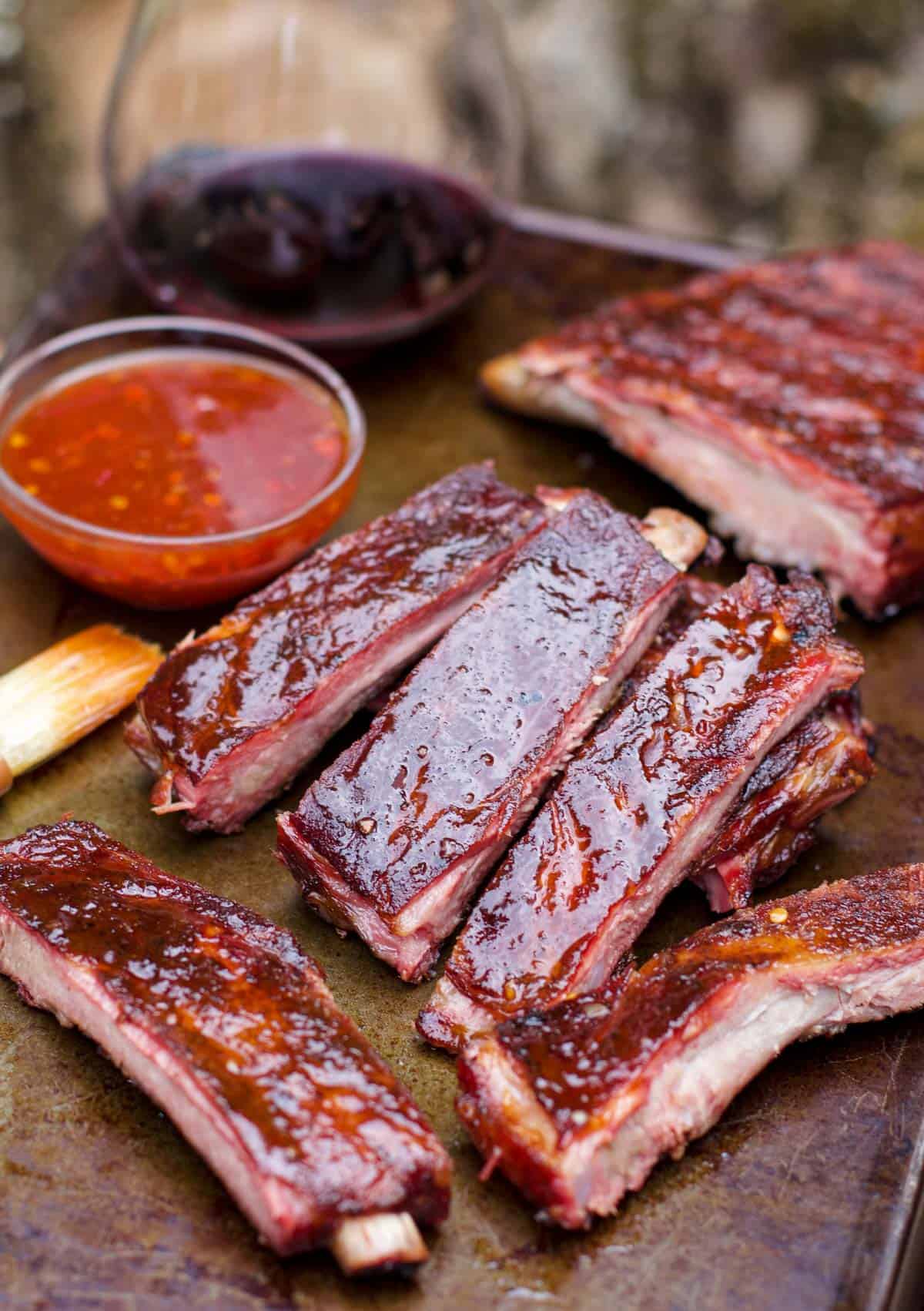 Thai sweet chili sauced ribs with wine pairing on a tray.