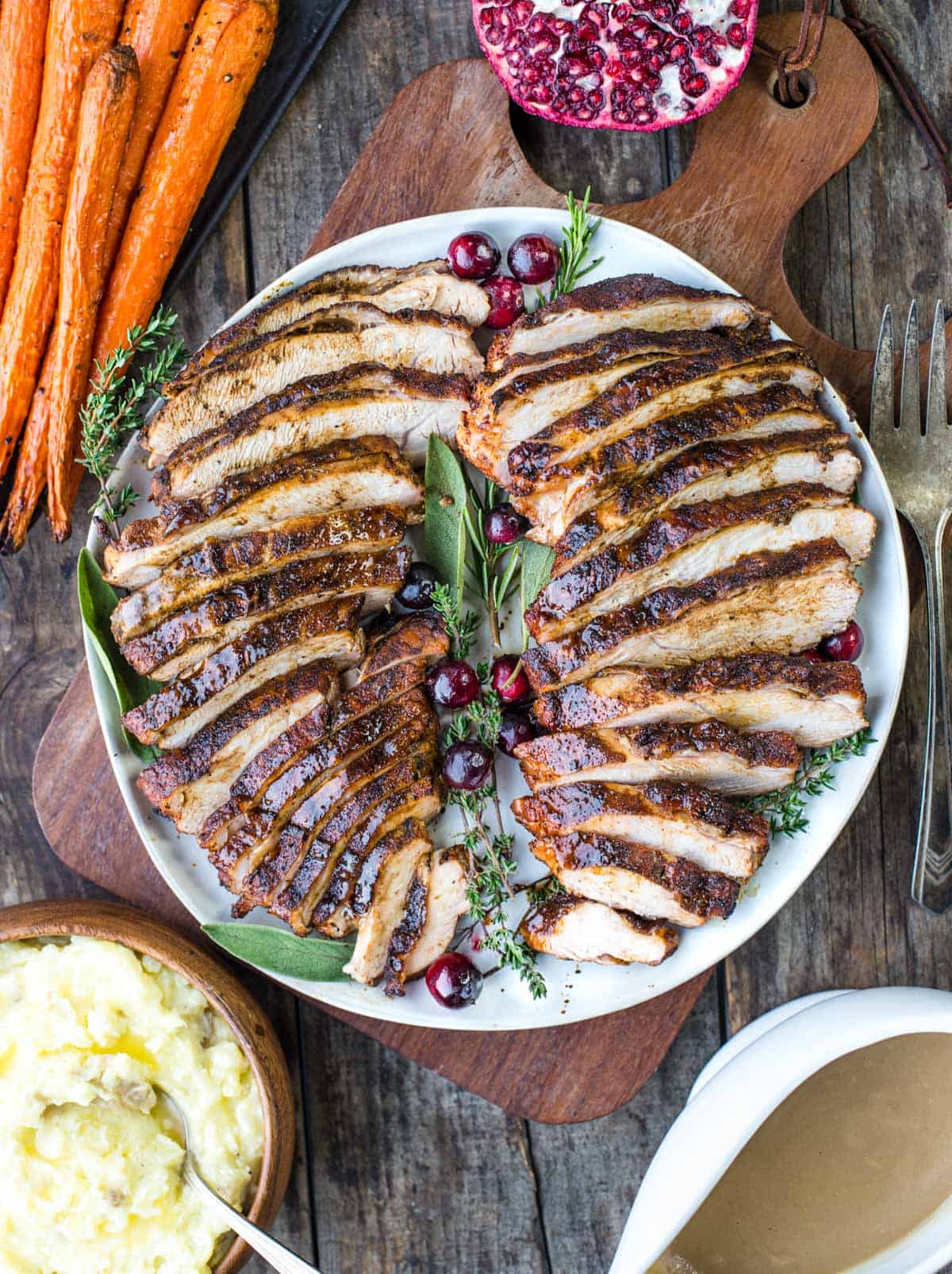 Sliced and grilled cajun spiced turkey breast with gravy and sides.