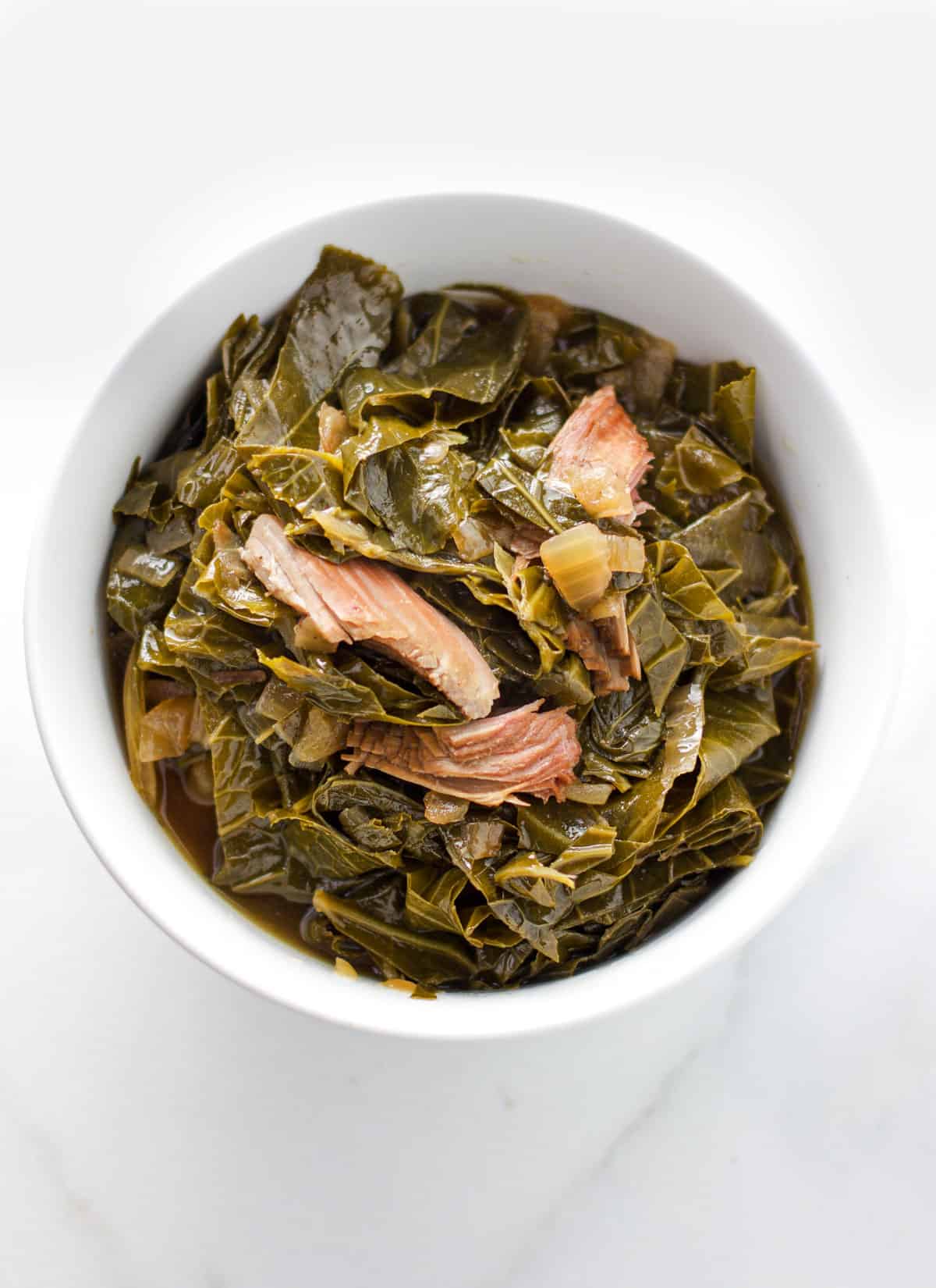 Collard greens in a bowl with smoked turkey.