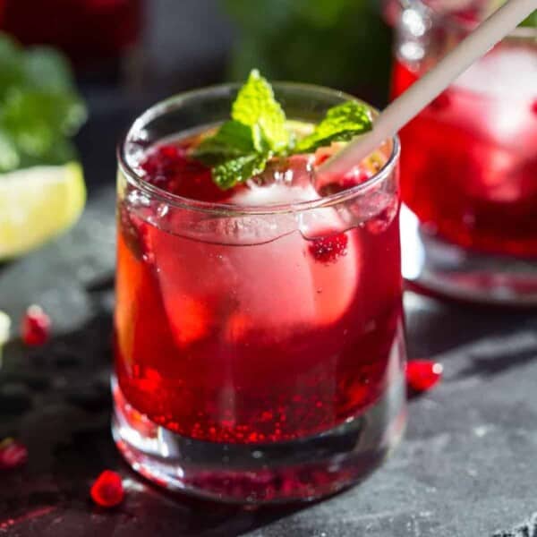 Ginger pomegranate cocktail in a glass with mint.