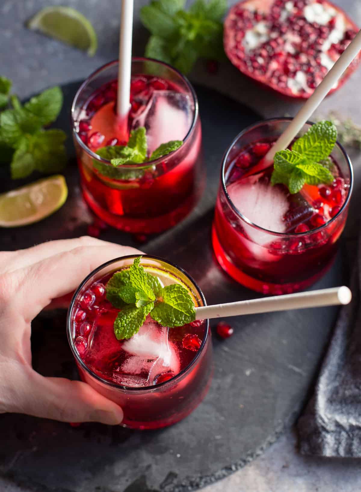 Three glasses filled with ginger pomegranate cocktails