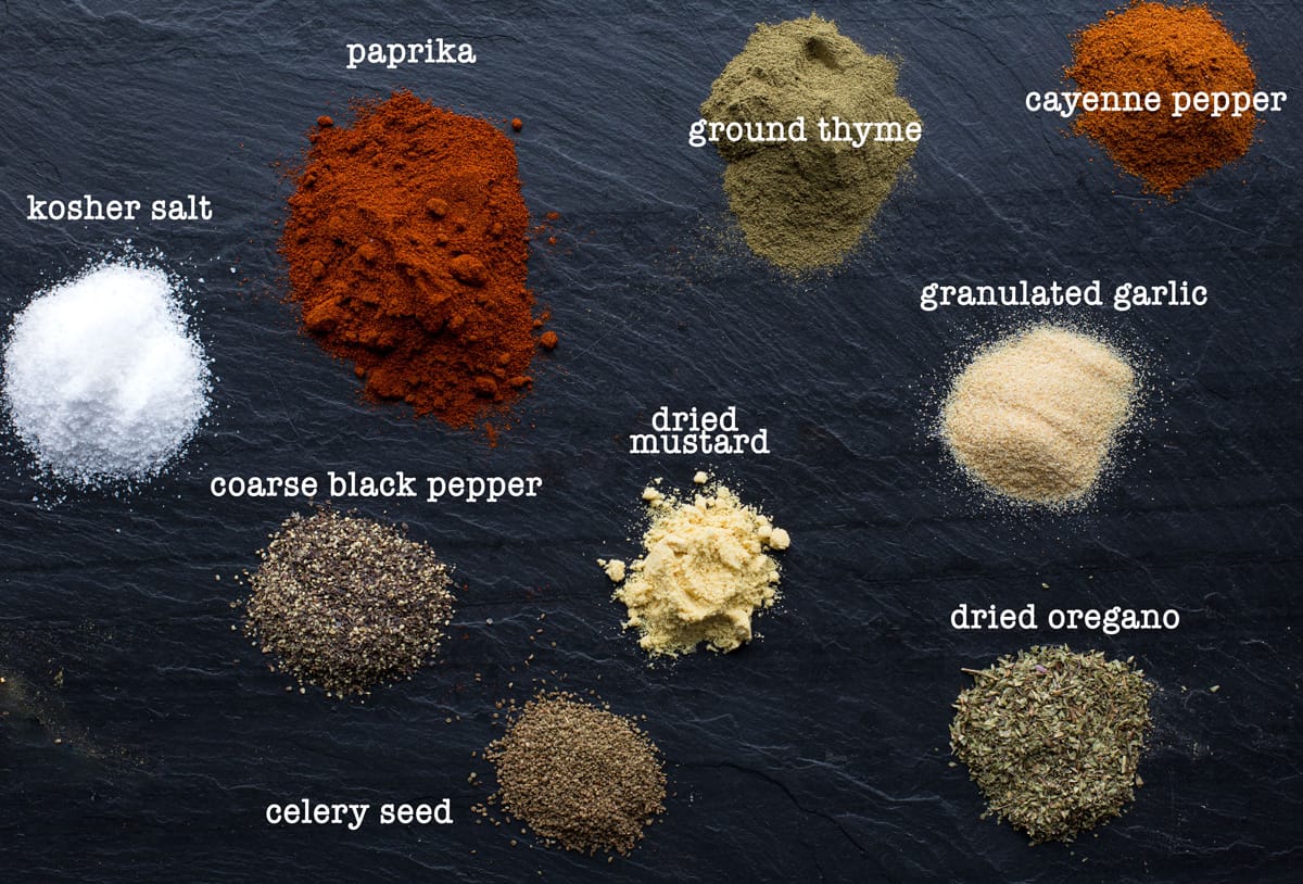 Ingredients for Cajun seasoning on a black slate plate