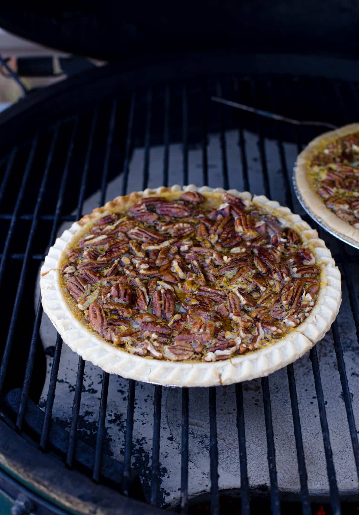 A pecan pie cooking on the grill