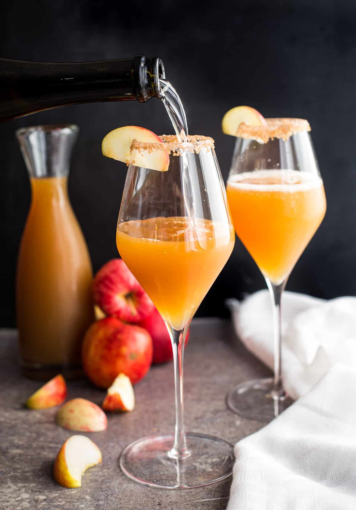 Apple cider mimosas in a champagne flute.