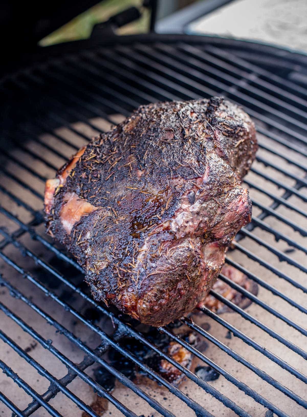 A bone in leg of lamb on a smoker