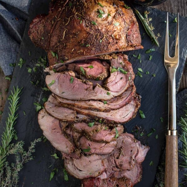 A smoked leg of lamb on a platter
