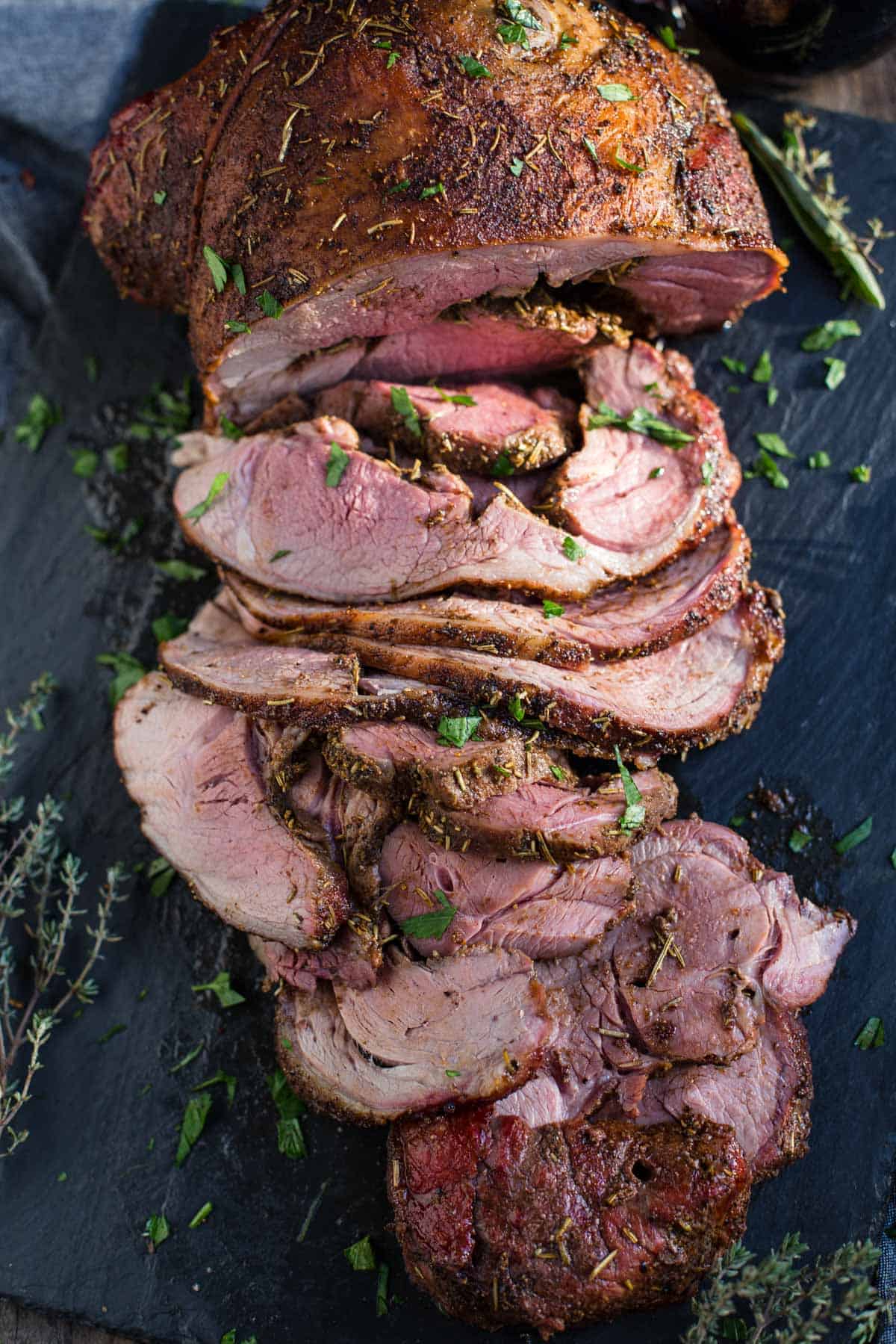 Slices of boneless smoked leg of lamb on a platter