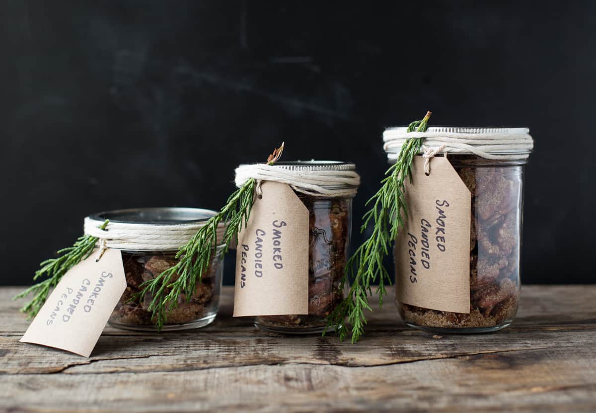 Three mason jars filled with smoked candied nuts