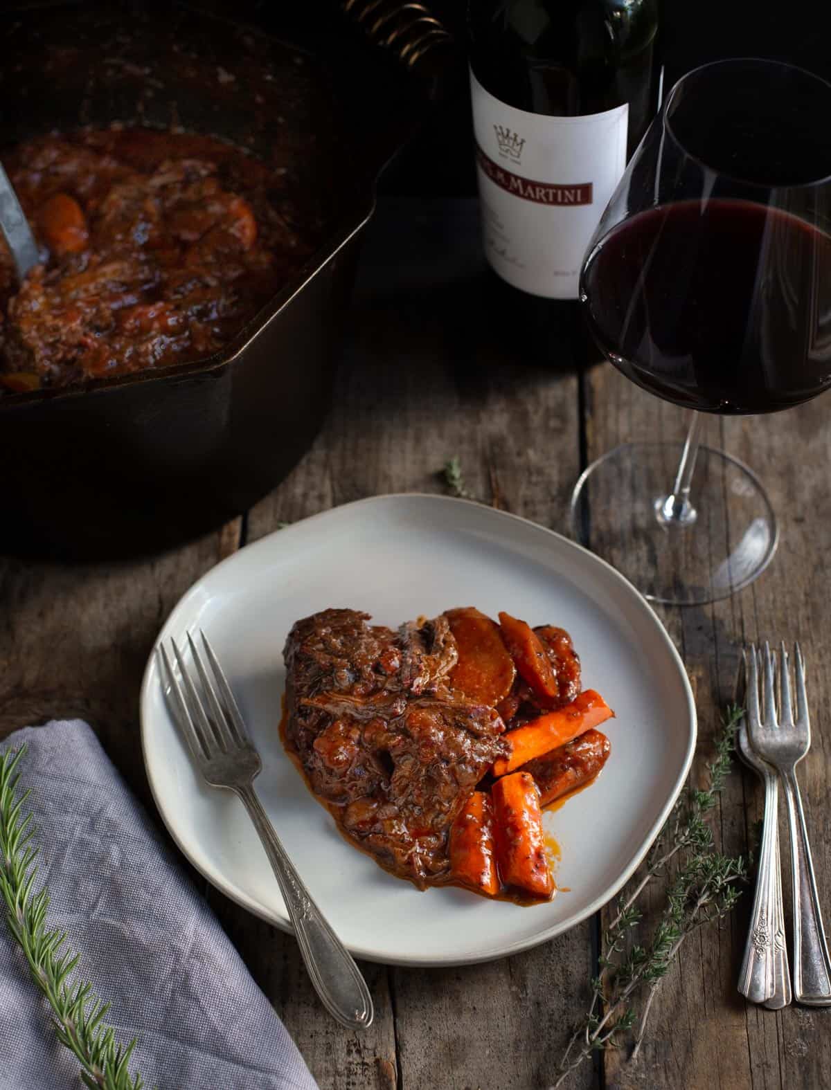 A plate of Smoked Pot Roast served with a glass of Red Wine