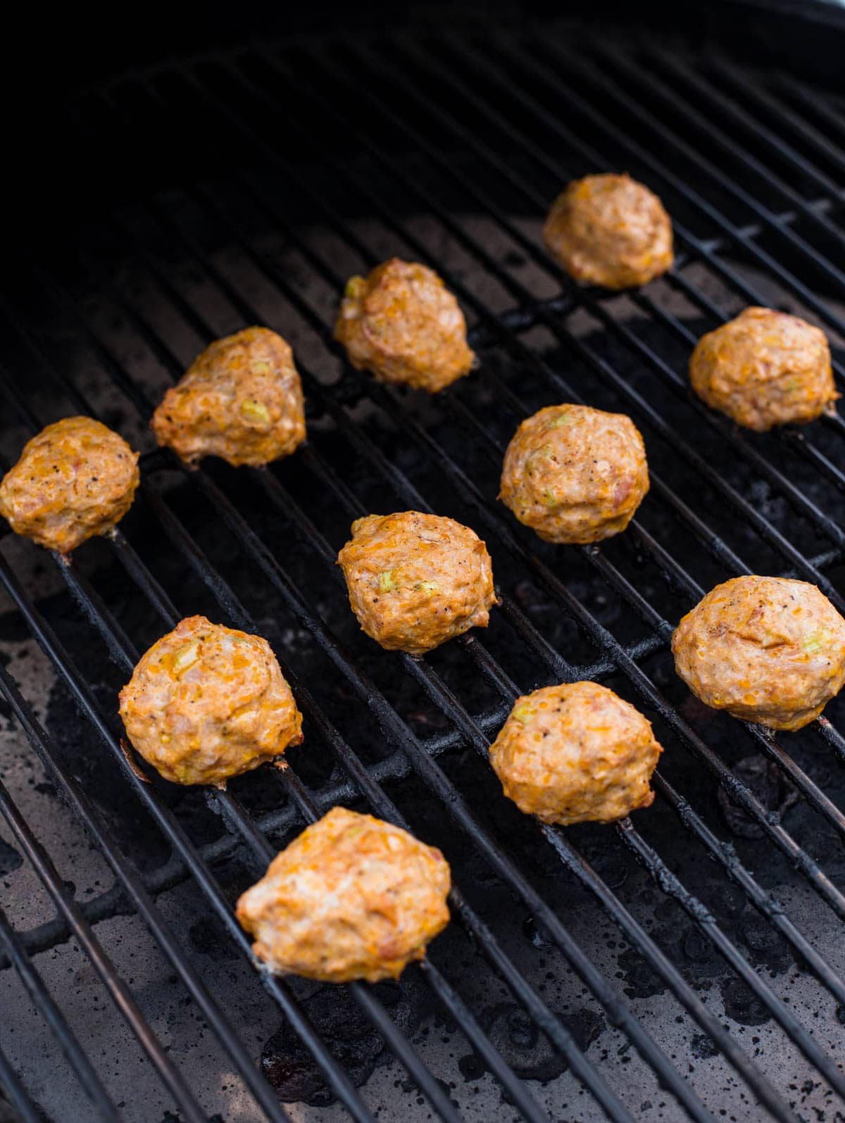 12 Meatballs cooking on a grill