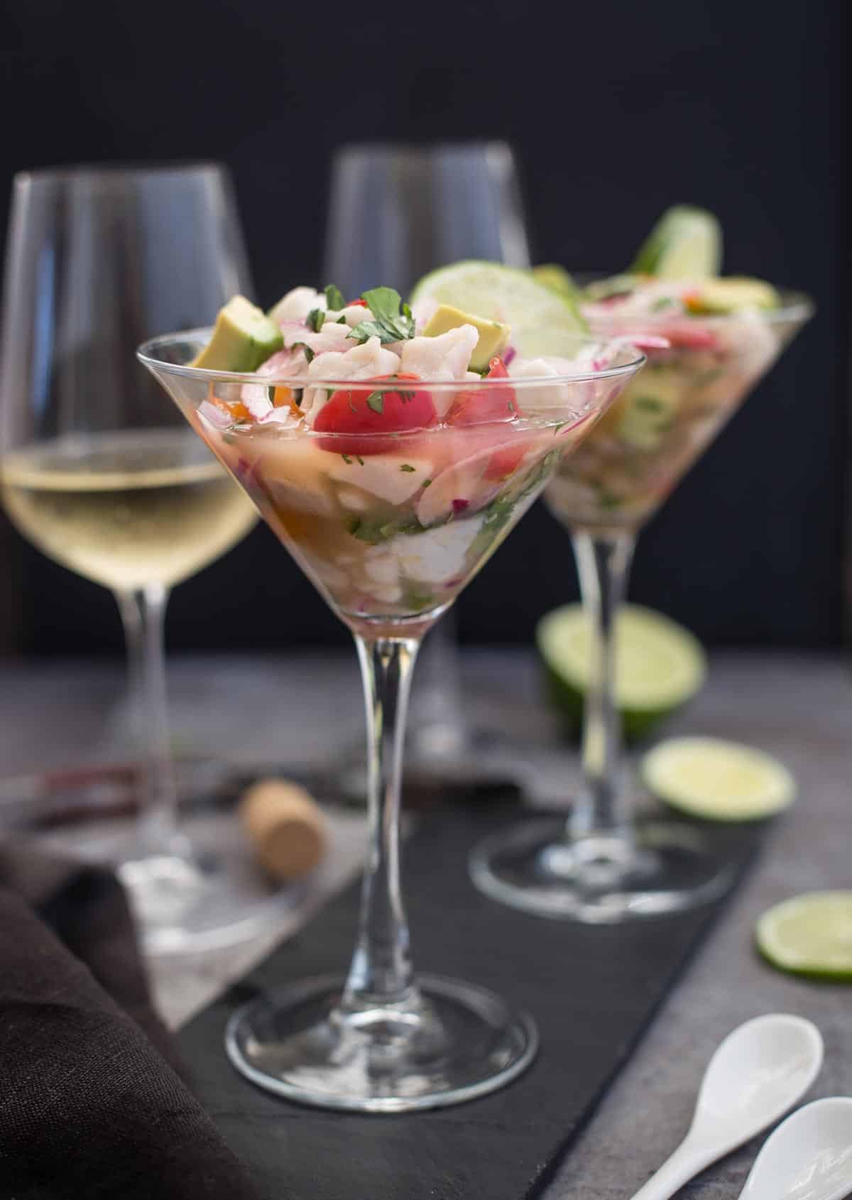 A glass with ceviche and a glass of Sauvignon Blanc wine
