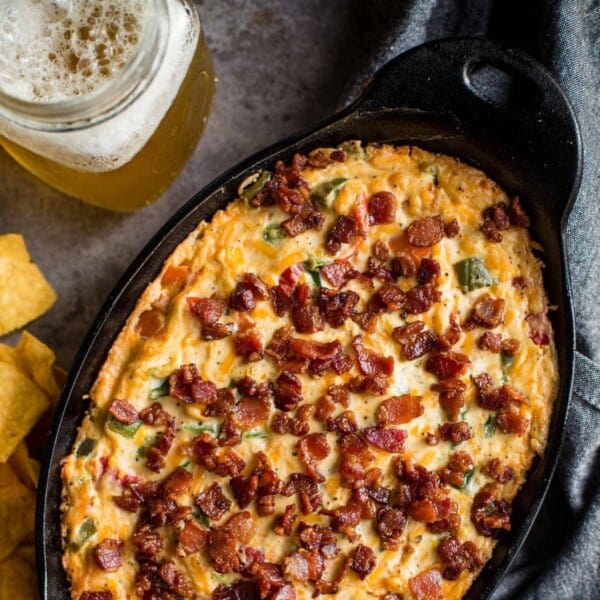 Jalapeno popper cheese dip in a cast iron pan.