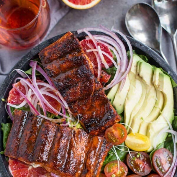 Grilled Salmon over salad in a bowl.