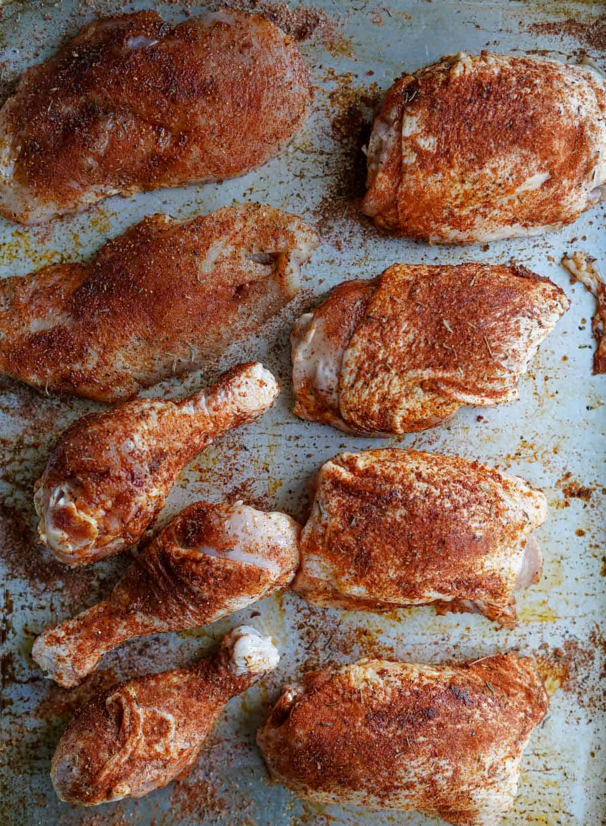 Jerk Seasoning coated onto pieces of raw chicken