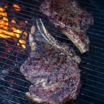 Two Ribeye Steaks cooking on a grill
