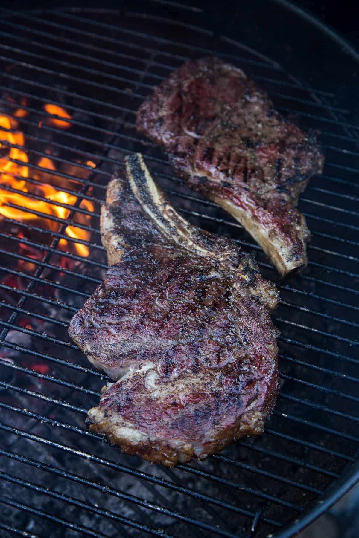 Two Ribeye Steaks cooking on a grill