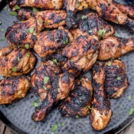 Pieces of grilled Jerk Chicken on a platter