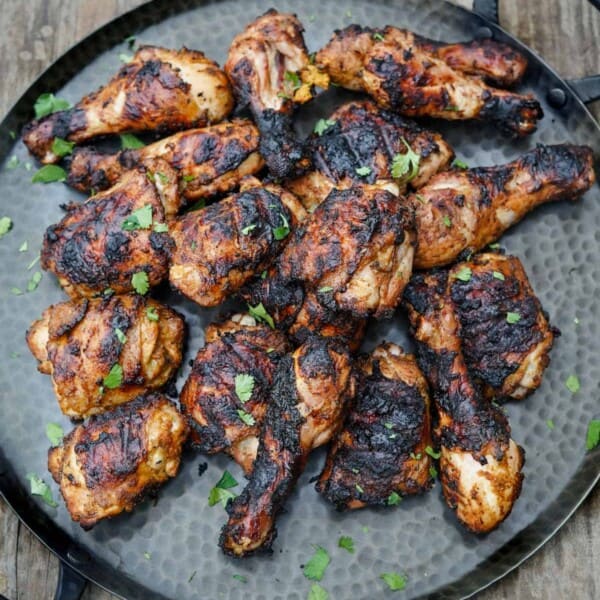 Spicy and aromatic Jerk chicken on a platter.