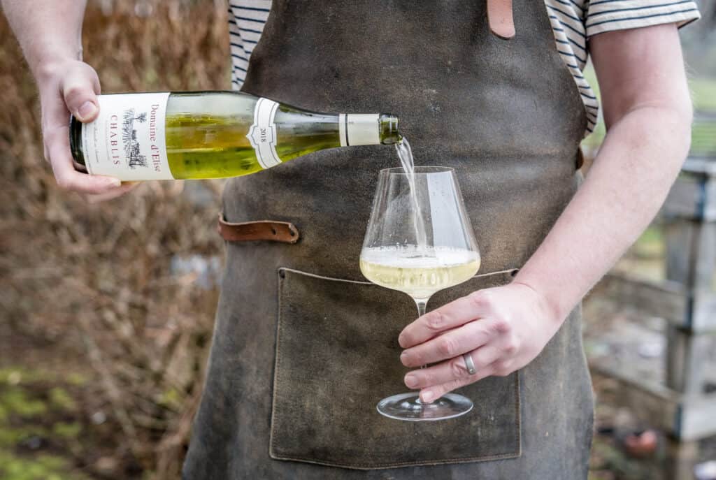 Chardonnay wine being poured into a wine glass