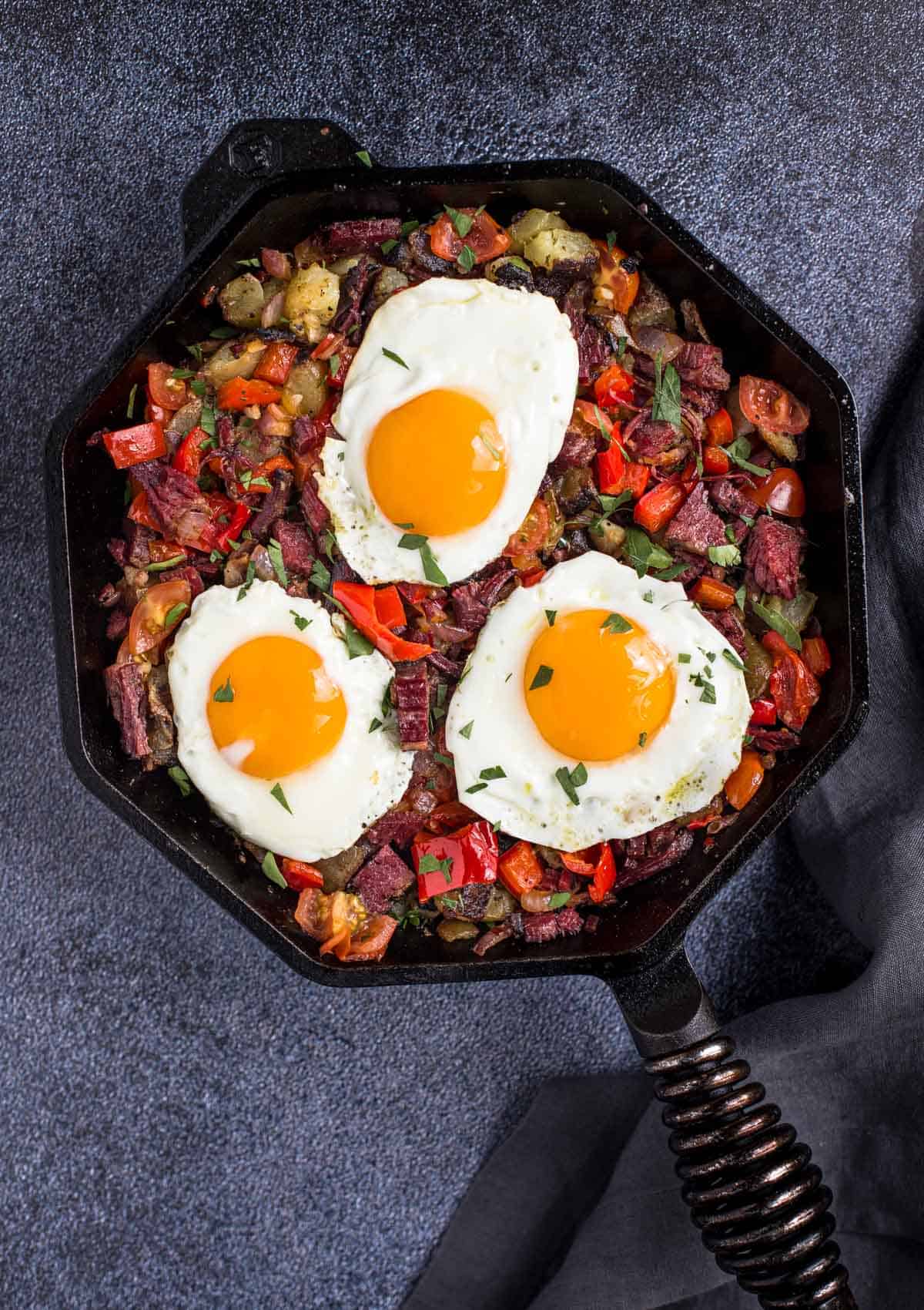 Skillet corned beef hash with eggs sunny side up.