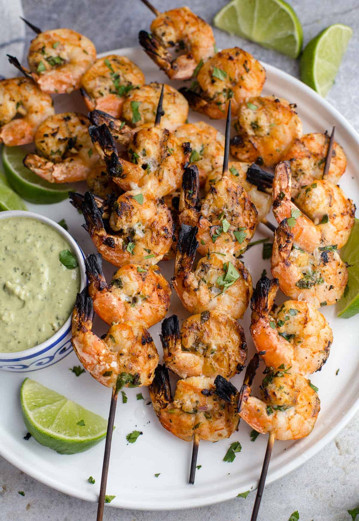 Grilled Cilantro Lime Shrimp on a platter with an Avocado Crema
 dipping sauce