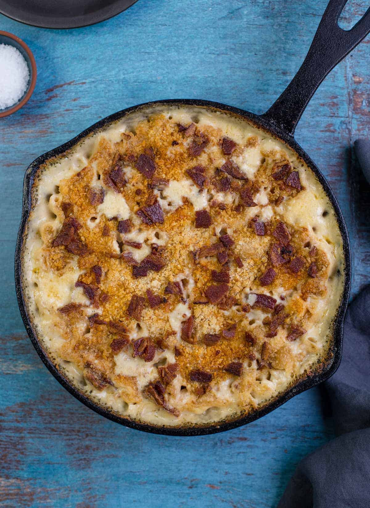 Grilled Mac and Cheese in a cast iron pan with bacon and panko topping.
