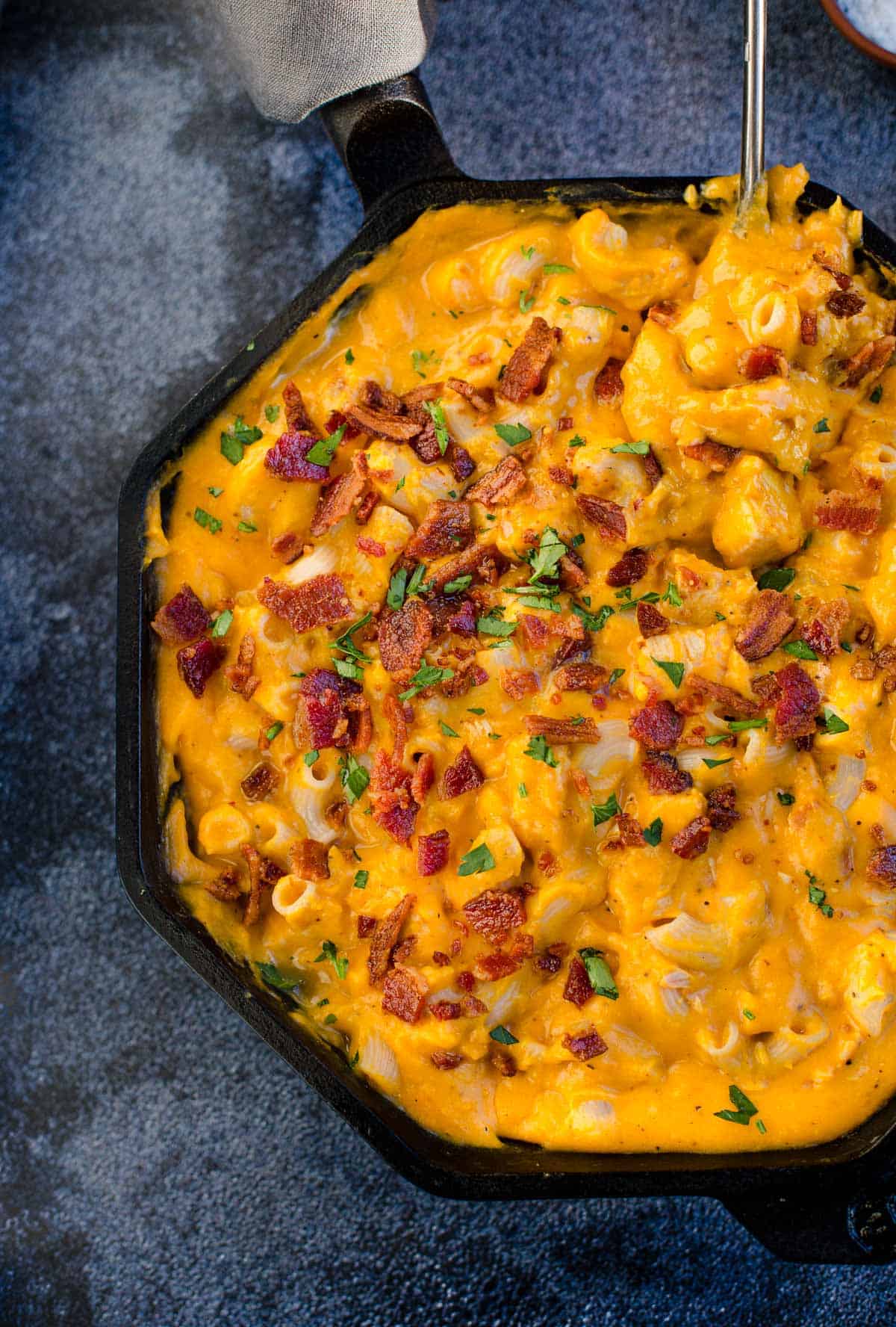 Smoked Butternut Mac and Cheese in a Cast Iron pan topped with bacon