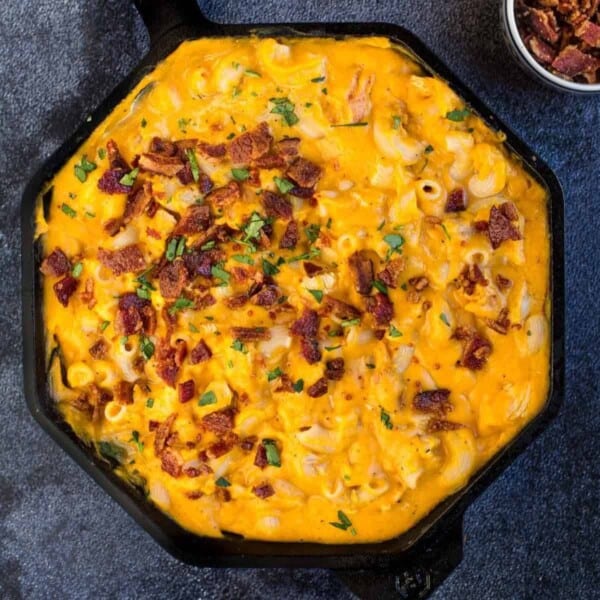 Butternut squash mac and cheese in Cast Iron pan topped with bacon.