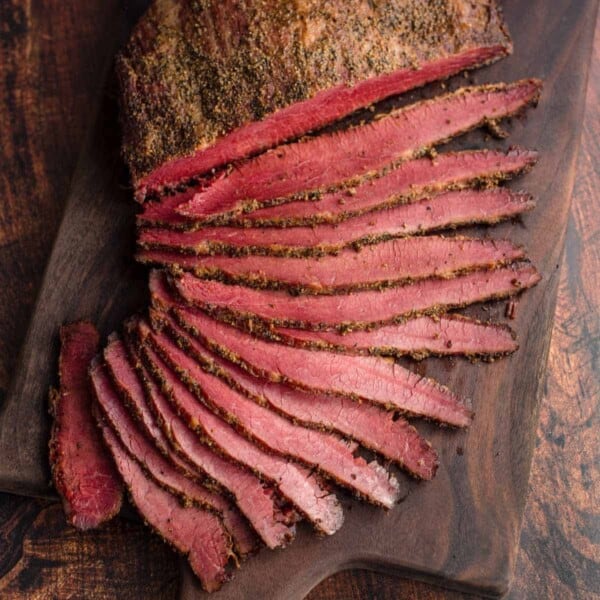 smoked corned beef brisket slices on a cutting board.