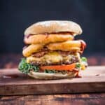 Western Cheeseburger with Onion Rings on a wood board