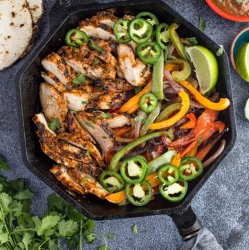 grilled chicken fajitas in a cast iron skillet