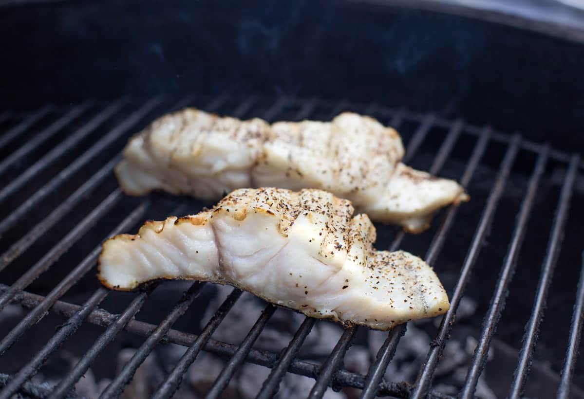 Two halibut filets cooking on the grill
