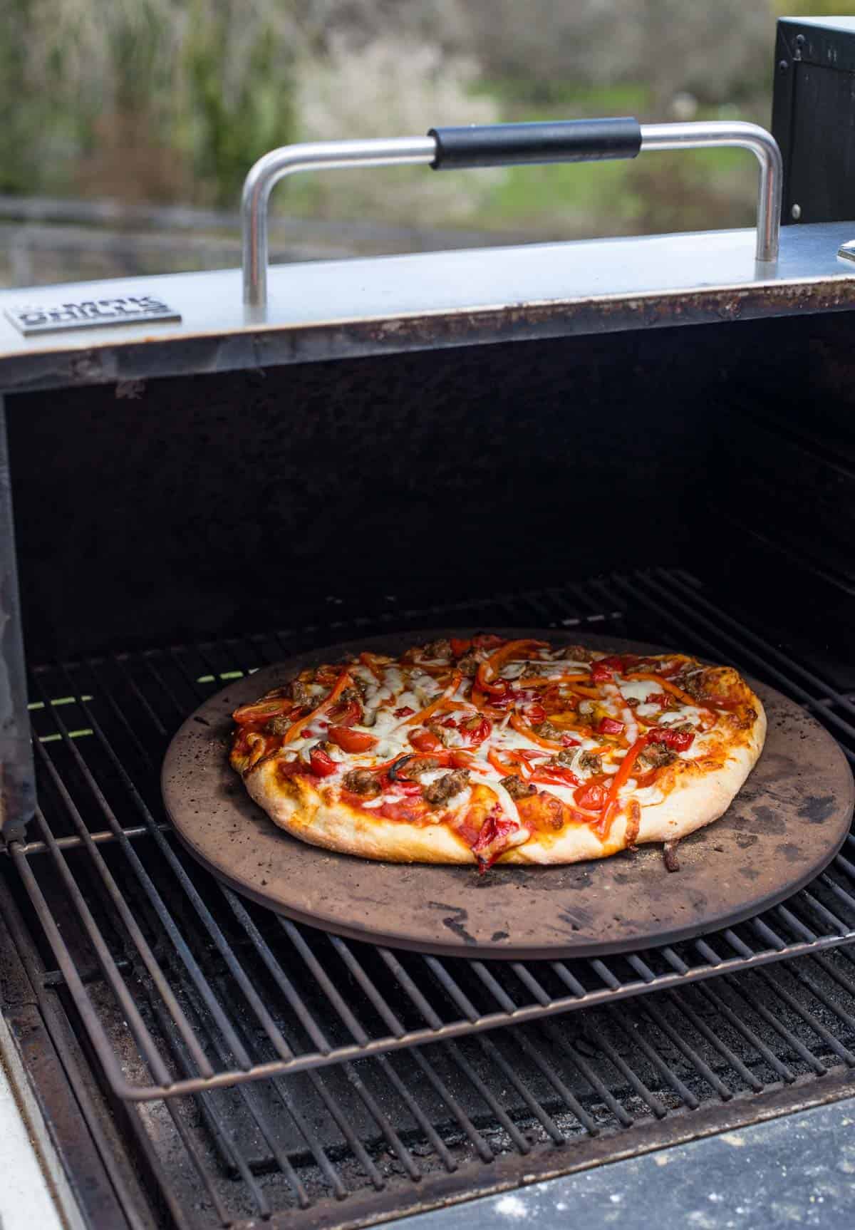 A pizza cooking on a MAK Pellet Grill 
