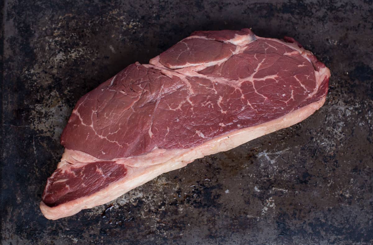 A raw sirloin steak on a plate